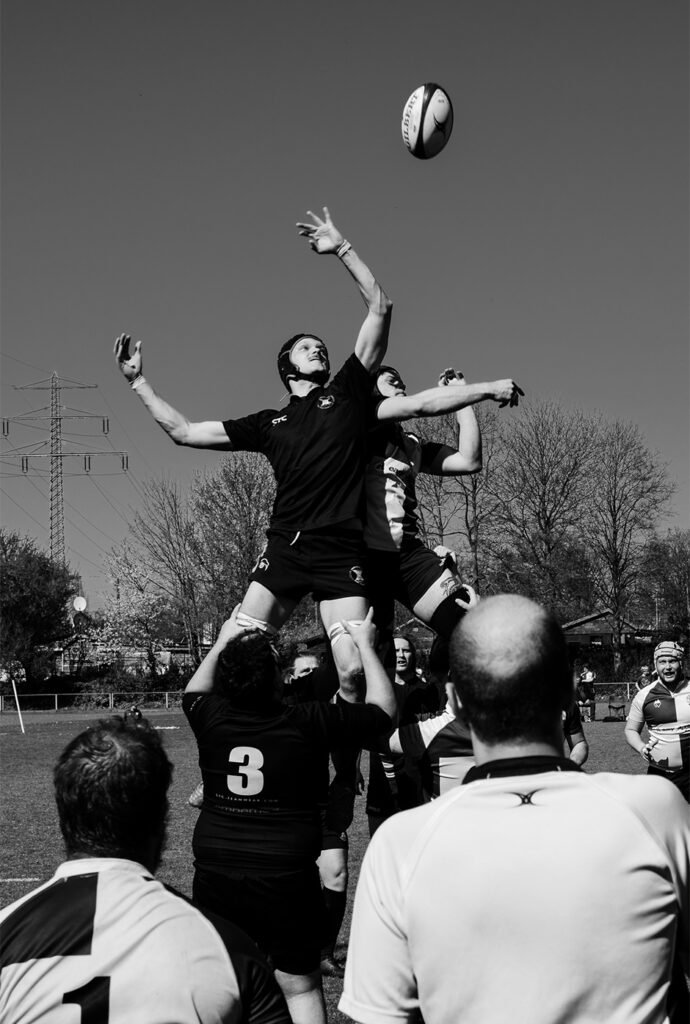Rugby players striking the rugby ball during a match